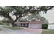 Lovely single-story home featuring mature landscaping and a brick driveway leading to the garage at 1001 Brookside Dr, Clearwater, FL 33764