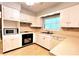 Functional kitchen featuring white cabinetry and essential appliances at 1001 Brookside Dr, Clearwater, FL 33764