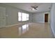 Bright living room with neutral walls, ceiling fan, and large window at 1001 Brookside Dr, Clearwater, FL 33764