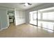 Open-concept living area featuring built-in shelving and sliding glass doors at 1001 Brookside Dr, Clearwater, FL 33764