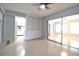 Open-concept living area with built-in shelving and sliding glass doors at 1001 Brookside Dr, Clearwater, FL 33764
