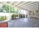 A screened patio with a concrete floor and a view of the lush greenery at 1001 Brookside Dr, Clearwater, FL 33764