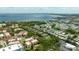 Wide aerial shot showing the community close to water with mature trees, condos, and mobile homes at 1012 Pearce Dr # 304, Clearwater, FL 33764