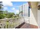 This balcony has a unique white railing and a brown floor overlooking lush greenery with an exterior building view at 1012 Pearce Dr # 304, Clearwater, FL 33764