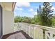 Inviting balcony with patterned railings, offering serene views of lush greenery and a clear blue sky at 1012 Pearce Dr # 304, Clearwater, FL 33764