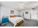 Cozy bedroom with gray carpet, complemented by soft lighting and a tranquil view of the ensuite bathroom at 1012 Pearce Dr # 304, Clearwater, FL 33764