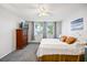 Bedroom featuring a bed, dresser, ceiling fan, and large windows at 1012 Pearce Dr # 304, Clearwater, FL 33764