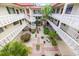 This building has an open courtyard with beautiful landscaping, white railing, and stairs at 1012 Pearce Dr # 304, Clearwater, FL 33764