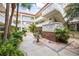 Well-maintained courtyard features a fountain and chairs, complemented by lush tropical landscaping at 1012 Pearce Dr # 304, Clearwater, FL 33764