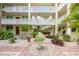 Serene courtyard view with lush plants, a bench, and decorative stone and brick pathways at 1012 Pearce Dr # 304, Clearwater, FL 33764