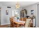 Dining room with wood table, chairs, chandelier, and view into kitchen at 1012 Pearce Dr # 304, Clearwater, FL 33764