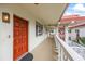 Exterior shot of a red door and a long hallway featuring the building architecture and design at 1012 Pearce Dr # 304, Clearwater, FL 33764