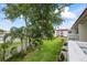 Beautiful exterior view of the landscaping with a mature shade tree, palms, and other buildings from the balcony at 1012 Pearce Dr # 304, Clearwater, FL 33764