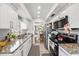 Galley kitchen features granite countertops, stainless steel appliances, and white cabinetry at 1012 Pearce Dr # 304, Clearwater, FL 33764