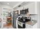 Modern kitchen features stainless steel appliances, granite counters, and white cabinets at 1012 Pearce Dr # 304, Clearwater, FL 33764