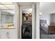 Laundry closet featuring a stackable washer and dryer, with a view into the bathroom and bedroom at 1012 Pearce Dr # 304, Clearwater, FL 33764