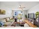 Comfortable living room with ceiling fan, and sliding glass doors to the outdoor patio at 1012 Pearce Dr # 304, Clearwater, FL 33764