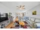 Spacious living room with a large sectional sofa, hardwood floors, and a view to the dining area at 1012 Pearce Dr # 304, Clearwater, FL 33764