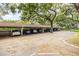 Covered parking area with multiple parking spots and mature shade trees at 1012 Pearce Dr # 304, Clearwater, FL 33764
