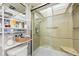 Detailed view of a shower with a glass door, grab bars, and a built-in seat, promoting accessibility at 1012 Pearce Dr # 304, Clearwater, FL 33764