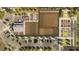 Overhead view of the community farm and garden showcasing organized crop rows, greenhouses, and parking areas at 10242 Gentle Rain Dr, Land O Lakes, FL 34638