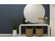 Stylish entryway featuring a round mirror, console table with woven baskets, and sleek decor at 10242 Gentle Rain Dr, Land O Lakes, FL 34638