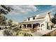 Bright and airy farmhouse with a charming wrap-around porch, verdant garden and vibrant blooms at 10242 Gentle Rain Dr, Land O Lakes, FL 34638