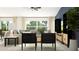 Cozy living room with stylish furniture, including a comfortable sofa and modern chairs, with ample natural light at 10242 Gentle Rain Dr, Land O Lakes, FL 34638
