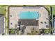 Aerial view of the community pool, surrounded by lounge chairs and lush landscaping, perfect for summer relaxation at 11922 Winterset Cove Dr, Riverview, FL 33579