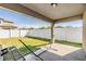 Covered patio opens to a spacious backyard with a privacy fence, perfect for outdoor entertaining and relaxation at 11922 Winterset Cove Dr, Riverview, FL 33579