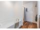 Well-lit bathroom offers a soaking tub, shower with curtain, and unique flooring for a spa-like feel at 11922 Winterset Cove Dr, Riverview, FL 33579
