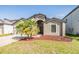 Inviting home with a manicured lawn, mature landscaping, and a welcoming entrance at 11922 Winterset Cove Dr, Riverview, FL 33579