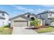 Attractive single-Gathering home boasts a two-car garage, manicured lawn, and beautiful front yard landscaping at 11922 Winterset Cove Dr, Riverview, FL 33579