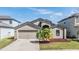 Charming home with a two-car garage, lush landscaping, and a well-manicured lawn at 11922 Winterset Cove Dr, Riverview, FL 33579