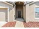 Inviting front entrance with a dark-colored door and decorative landscaping at 11922 Winterset Cove Dr, Riverview, FL 33579