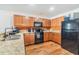 Cozy kitchen featuring stainless steel appliances, wood cabinets, and laminate floor at 11922 Winterset Cove Dr, Riverview, FL 33579