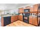 Well-lit kitchen with a view into the living area, featuring dark appliances at 11922 Winterset Cove Dr, Riverview, FL 33579