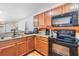Well-equipped kitchen featuring stainless steel appliances and warm wood cabinetry at 11922 Winterset Cove Dr, Riverview, FL 33579