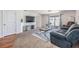 Cozy living room features a large television, stylish console, and sliding glass door for ample natural light at 11922 Winterset Cove Dr, Riverview, FL 33579