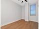 Cozy bedroom with hardwood floors, a ceiling fan, and large window offering natural light at 1208 E Kennedy Blvd # 1121, Tampa, FL 33602