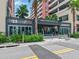 The contemporary-designed building features a modern entrance with well-maintained landscaping at 1208 E Kennedy Blvd # 1121, Tampa, FL 33602