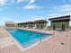 Large in-ground pool with brick paver decking, handrails and cabana-style changing rooms at 1208 E Kennedy Blvd # 1121, Tampa, FL 33602