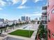A rooftop view of a large community pool, cabanas and lush green spaces at 1208 E Kennedy Blvd # 1121, Tampa, FL 33602