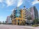 Upscale building featuring balconies, modern architecture, and lush palm trees set against a vibrant blue sky at 1208 E Kennedy Blvd # 1121, Tampa, FL 33602