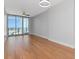 Bright, open living room featuring hardwood floors, fan, and sliding glass doors to balcony at 1208 E Kennedy Blvd # 1121, Tampa, FL 33602
