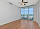 Sunlit living room boasts beautiful floors, ceiling fan, and access to a balcony at 1208 E Kennedy Blvd # 1121, Tampa, FL 33602