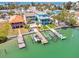 Aerial view of canal with boat docks and residences in a waterfront neighborhood at 12312 Lagoon Ln, Treasure Island, FL 33706