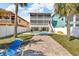 Beautiful backyard featuring a pool, patio and lawn with a view of the home and mature landscaping at 12312 Lagoon Ln, Treasure Island, FL 33706