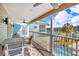 Outdoor balcony with furniture overlooking boats and a swimming pool at 12312 Lagoon Ln, Treasure Island, FL 33706