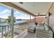 Relax on this screened balcony with comfortable seating, and panoramic views of the canal and waterfront at 12312 Lagoon Ln, Treasure Island, FL 33706
